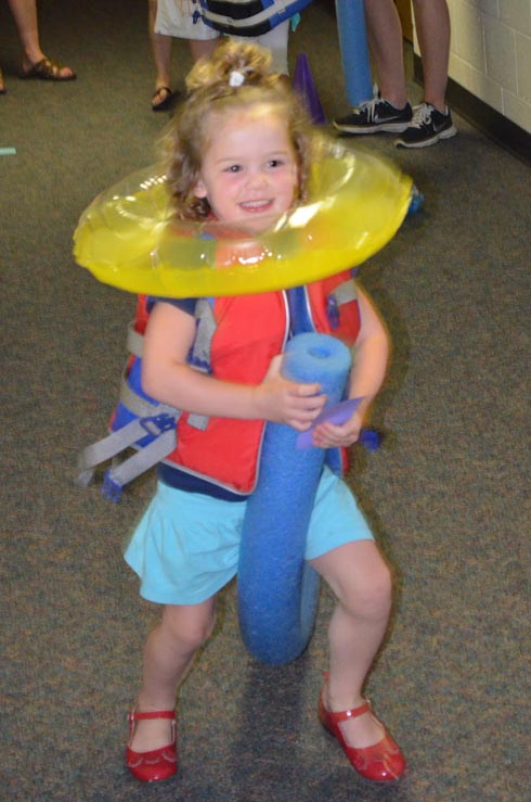 Girl Dressed with Float Ring, Goggles & Life Vest