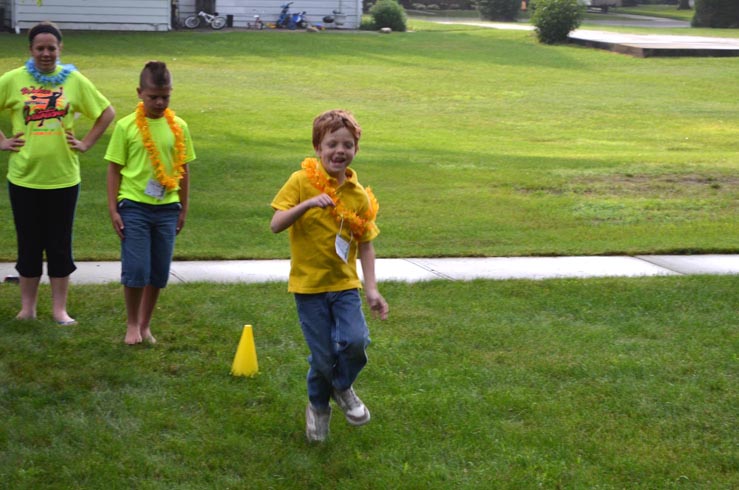 Boy Searching for Shell Clues in Sandy Water