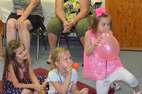 Children Blowing Up Balloons