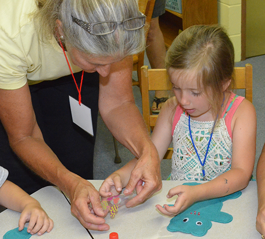 Deb Helping Child with Her Craft