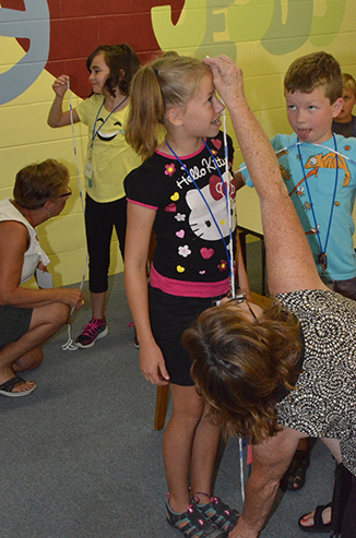 Becky Measures Height of Child After Measuring Arm Span