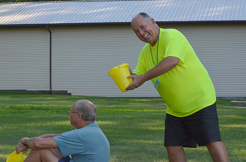 Dave Prepares to Surprise Warren with a Bucket of Water