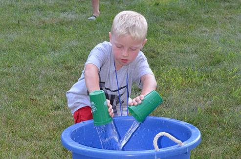 Child Dumping Glass of Water