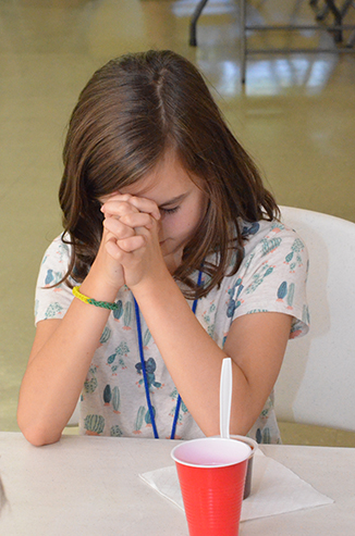Child Praying Before Snack