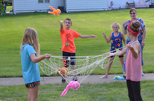 Child Tossing Stuffed Animal in Net