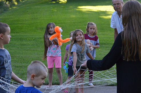 Child Tossing Stuffed Animal in Net