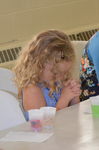 Child Praying Before Snack