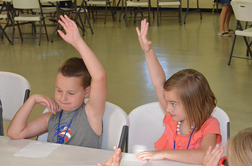 Children Discuss Bible with Leader During Snacks