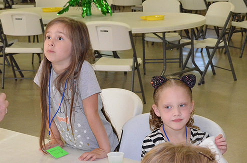 Children Discuss Bible with Leader During Snacks