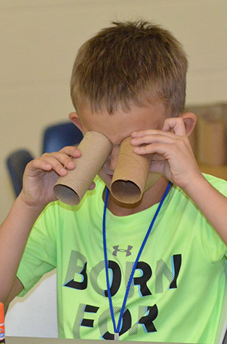 Child Testing His Binoculars