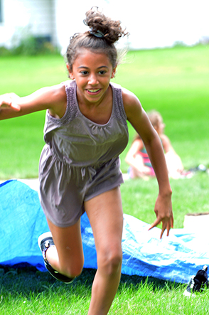 Child Emerges from Under Tarp