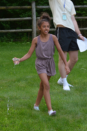 Child Walking with Cup of Water