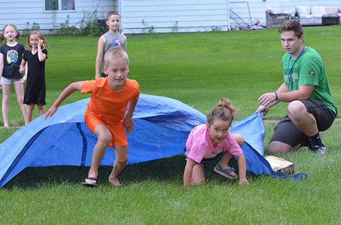 Children Emerge from Under Tarp