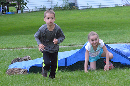 Children Emerge from Under Tarp