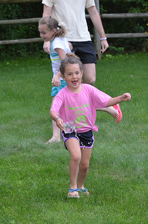 Child Walking with Cup of Water