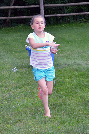 Child Walking with Cup of Water