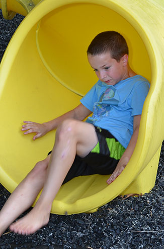 Child Going Down Slide